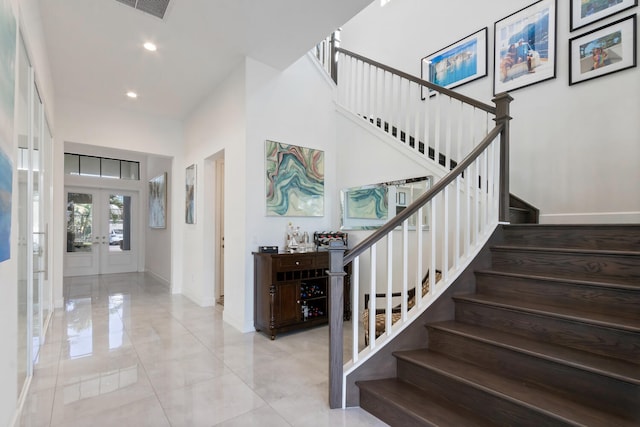 8451 Grand Prix Ln, Boynton Beach, FL 33472 - stairway with french doors, baseboards, a high ceiling, and recessed lighting