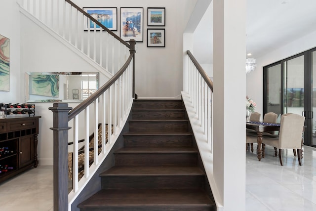 8451 Grand Prix Ln, Boynton Beach, FL 33472 - staircase with baseboards and a notable chandelier