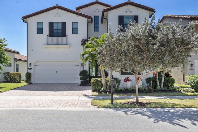 8451 Grand Prix Ln, Boynton Beach, FL 33472 - mediterranean / spanish house featuring a tile roof, decorative driveway, an attached garage, and stucco siding