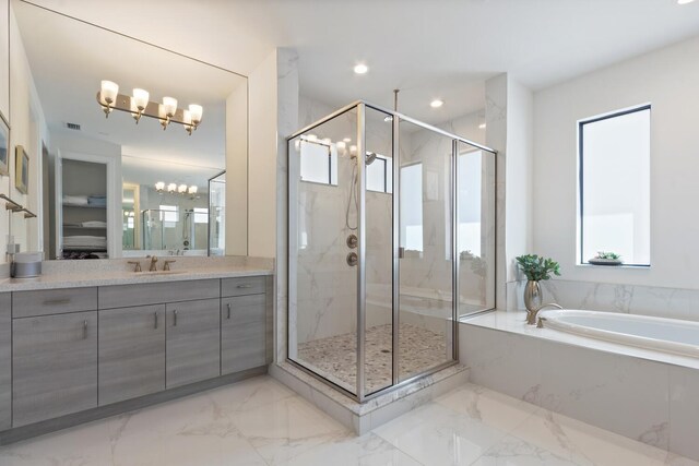 8451 Grand Prix Ln, Boynton Beach, FL 33472 - full bathroom featuring vanity, marble finish floor, a stall shower, a garden tub, and a notable chandelier