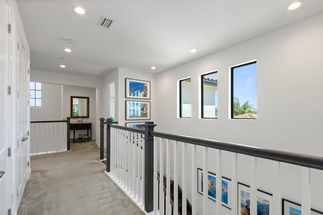 8451 Grand Prix Ln, Boynton Beach, FL 33472 - corridor featuring light colored carpet, visible vents, recessed lighting, and a healthy amount of sunlight