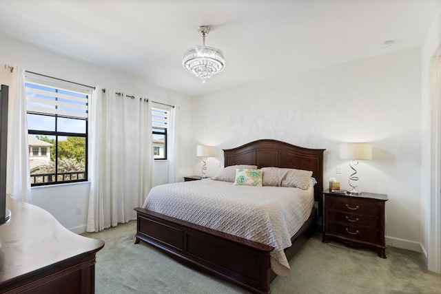 8451 Grand Prix Ln, Boynton Beach, FL 33472 - bedroom featuring light carpet, baseboards, and a notable chandelier