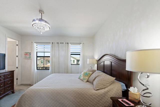 8451 Grand Prix Ln, Boynton Beach, FL 33472 - bedroom with carpet flooring and a notable chandelier
