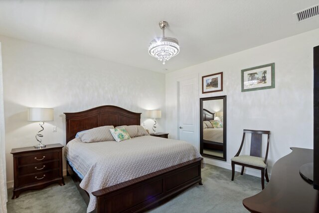 8451 Grand Prix Ln, Boynton Beach, FL 33472 - bedroom featuring light carpet, visible vents, and a chandelier