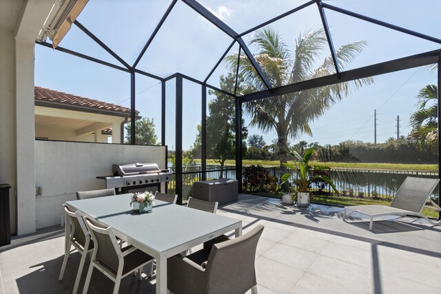 8451 Grand Prix Ln, Boynton Beach, FL 33472 - view of patio with a water view, outdoor dining area, area for grilling, and a lanai
