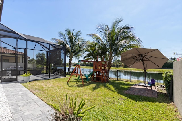 8451 Grand Prix Ln, Boynton Beach, FL 33472 - view of yard featuring glass enclosure, a fenced backyard, a patio, a water view, and a playground