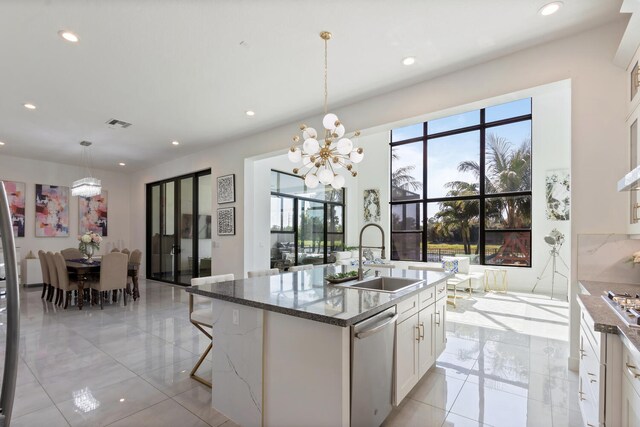 8451 Grand Prix Ln, Boynton Beach, FL 33472 - kitchen featuring dishwasher, a sink, an inviting chandelier, and a wealth of natural light