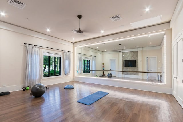 8451 Grand Prix Ln, Boynton Beach, FL 33472 - exercise area featuring a fireplace, visible vents, a ceiling fan, and wood finished floors