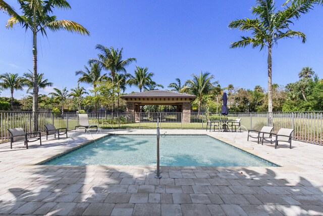 8451 Grand Prix Ln, Boynton Beach, FL 33472 - view of swimming pool with a patio area, a swimming pool, and fence