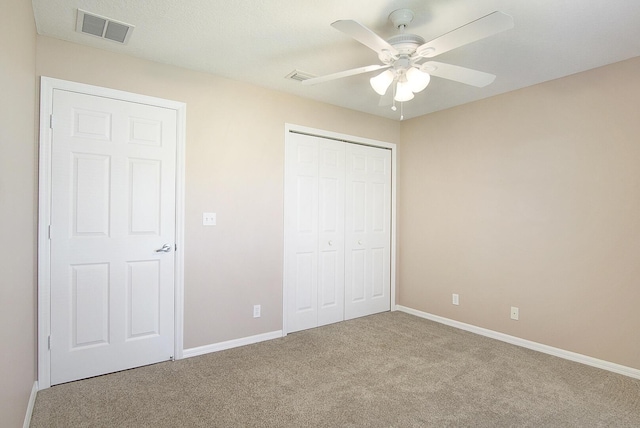 unfurnished bedroom with visible vents, ceiling fan, baseboards, carpet floors, and a closet