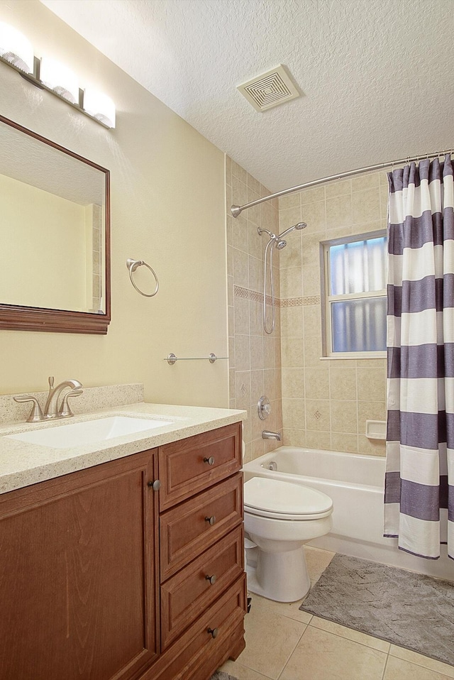bathroom featuring visible vents, vanity, shower / tub combo, tile patterned floors, and a textured ceiling
