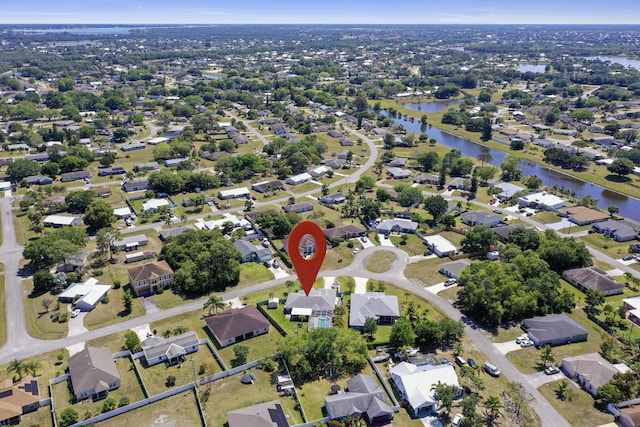 bird's eye view featuring a water view and a residential view