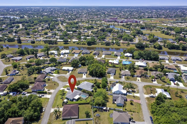 drone / aerial view featuring a residential view and a water view
