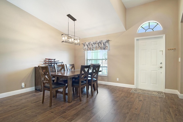 dining room with an inviting chandelier, baseboards, dark wood-style flooring, and vaulted ceiling