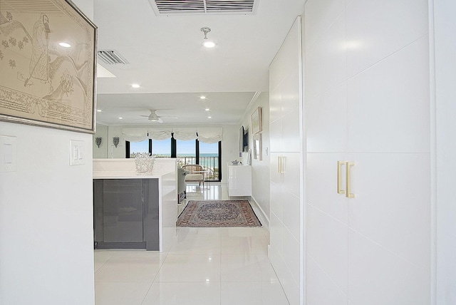 corridor featuring visible vents, tile patterned floors, and recessed lighting
