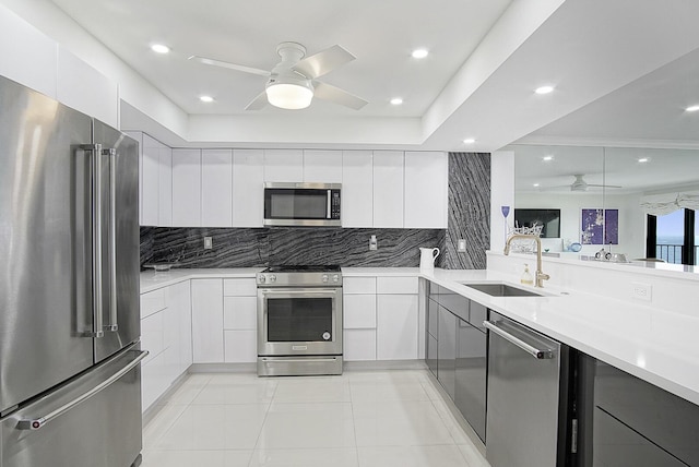 kitchen with modern cabinets, ceiling fan, a sink, and stainless steel appliances