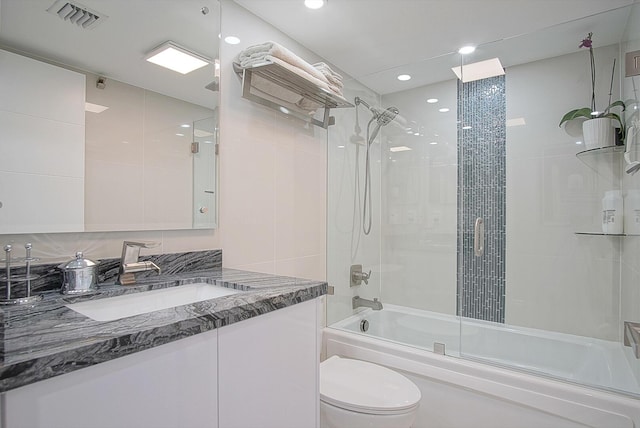 full bathroom with vanity, visible vents, recessed lighting, toilet, and bath / shower combo with glass door