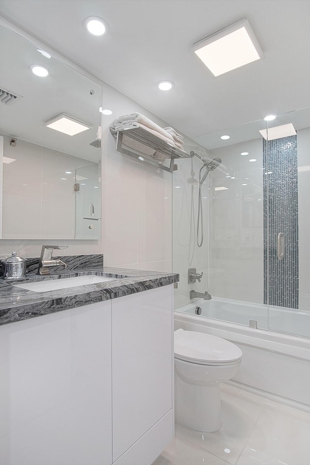 bathroom with toilet, combined bath / shower with glass door, visible vents, and recessed lighting