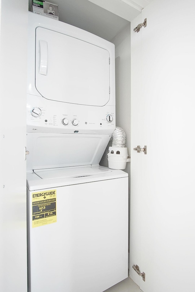 laundry room with stacked washer and dryer and laundry area