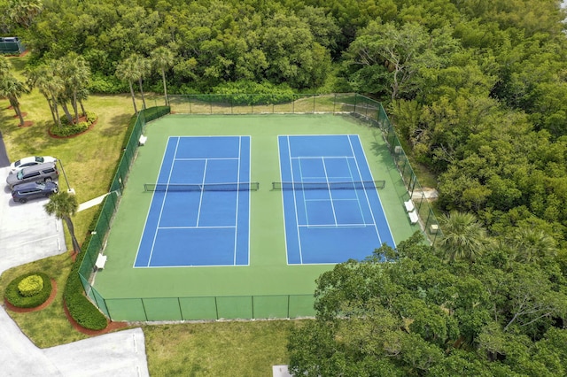 bird's eye view with a wooded view