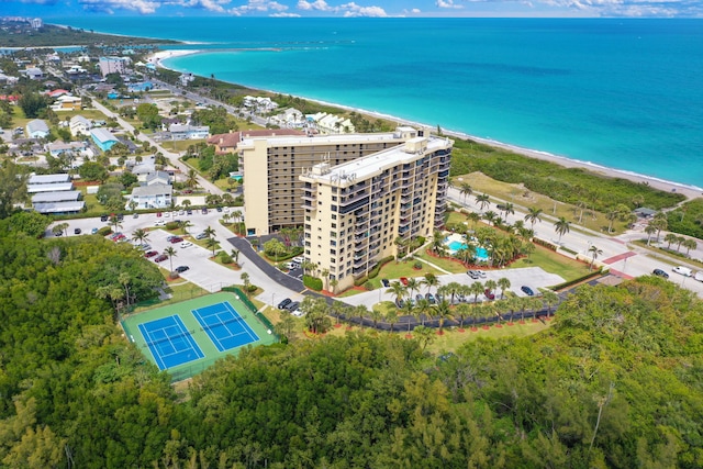 bird's eye view featuring a water view and a beach view