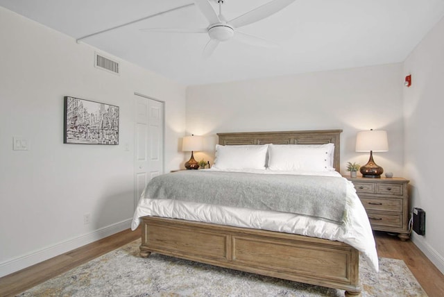 bedroom with baseboards, light wood-style floors, ceiling fan, and visible vents