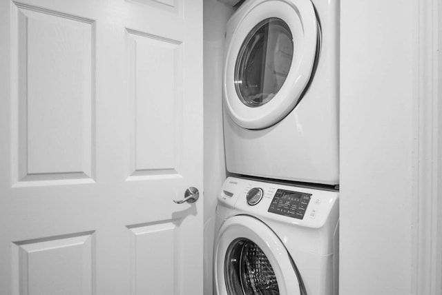 laundry room with stacked washer / dryer and laundry area