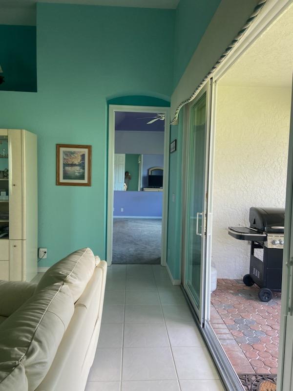 8047 Brindisi Ln, Boynton Beach, FL 33472 - hall featuring light tile patterned floors and light colored carpet