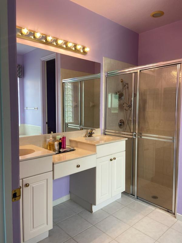8047 Brindisi Ln, Boynton Beach, FL 33472 - bathroom featuring tile patterned floors, a shower stall, and vanity
