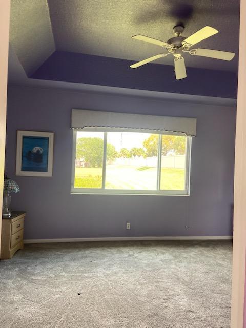 8047 Brindisi Ln, Boynton Beach, FL 33472 - carpeted spare room featuring plenty of natural light, baseboards, a raised ceiling, and a ceiling fan