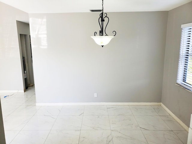 spare room with marble finish floor and baseboards