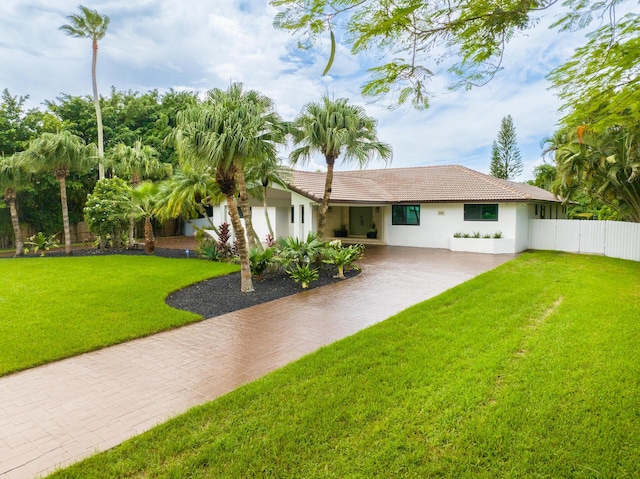 420 SW 128th Ave, Miami, FL 33184 - view of front of house featuring stucco siding, a tile roof, fence, and a front yard
