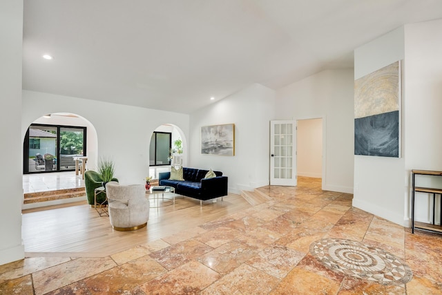 420 SW 128th Ave, Miami, FL 33184 - living room with stone tile floors, recessed lighting, high vaulted ceiling, baseboards, and arched walkways