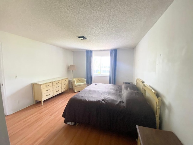 2721 SW 15th St Unit 202, Delray Beach, FL 33445 - bedroom with light wood finished floors and a textured ceiling