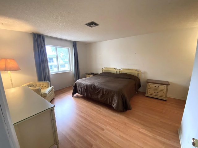2721 SW 15th St Unit 202, Delray Beach, FL 33445 - bedroom featuring light wood-style flooring and a textured ceiling