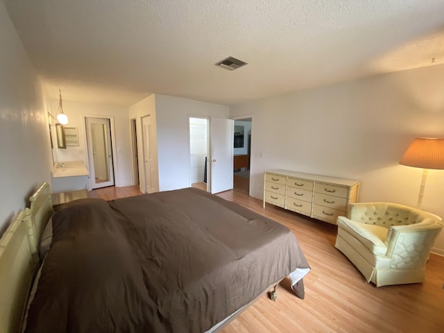 2721 SW 15th St Unit 202, Delray Beach, FL 33445 - bedroom featuring light wood finished floors and a textured ceiling