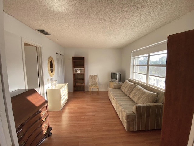 2721 SW 15th St Unit 202, Delray Beach, FL 33445 - living room with light wood-type flooring and a textured ceiling