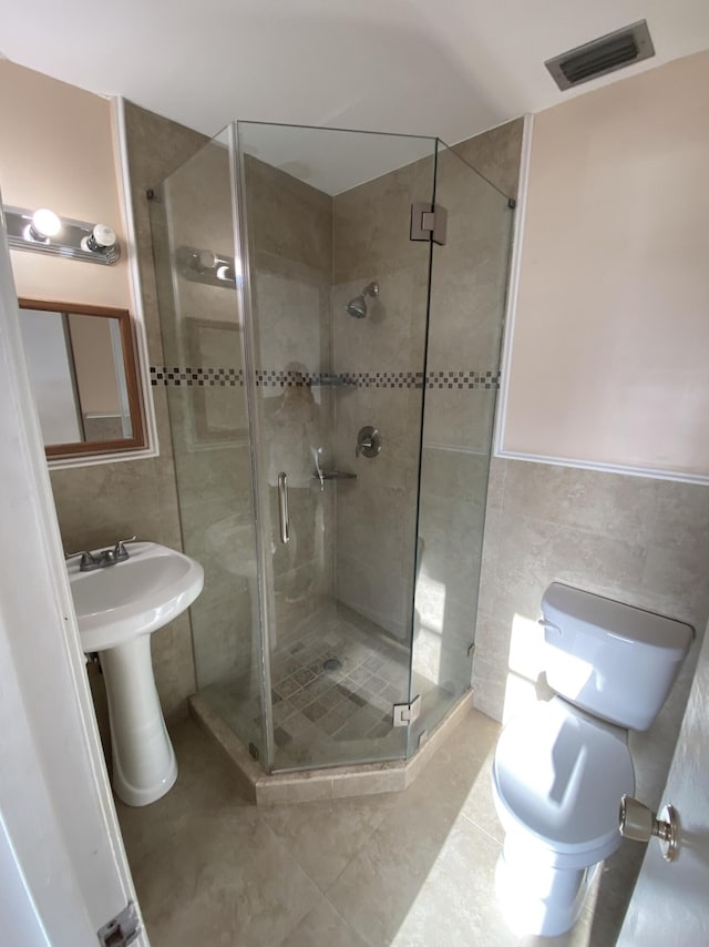 2721 SW 15th St Unit 202, Delray Beach, FL 33445 - full bathroom featuring tile walls, a shower stall, and tile patterned flooring