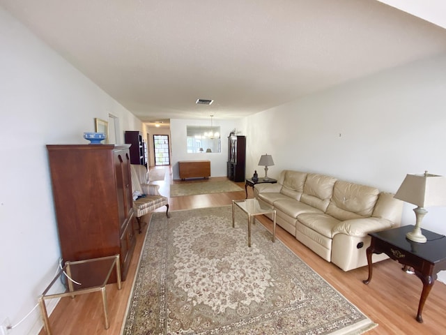 2721 SW 15th St Unit 202, Delray Beach, FL 33445 - living area featuring light wood finished floors and a chandelier