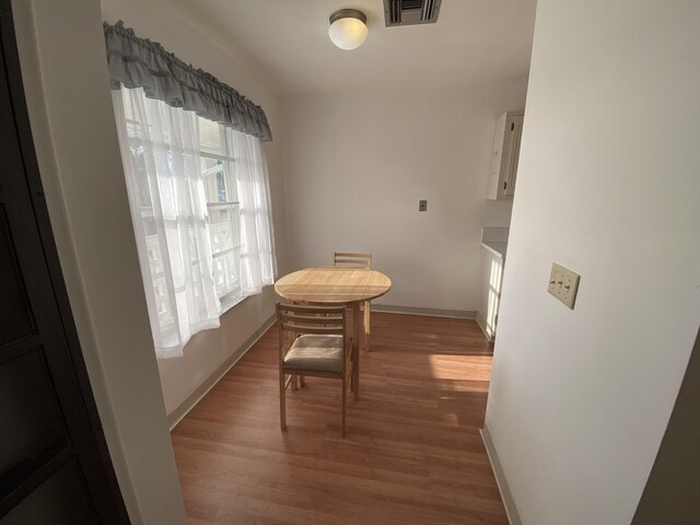 2721 SW 15th St Unit 202, Delray Beach, FL 33445 - dining space with light wood-type flooring and baseboards