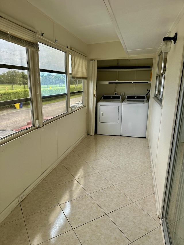 laundry room with washer and dryer, laundry area, and light tile patterned floors