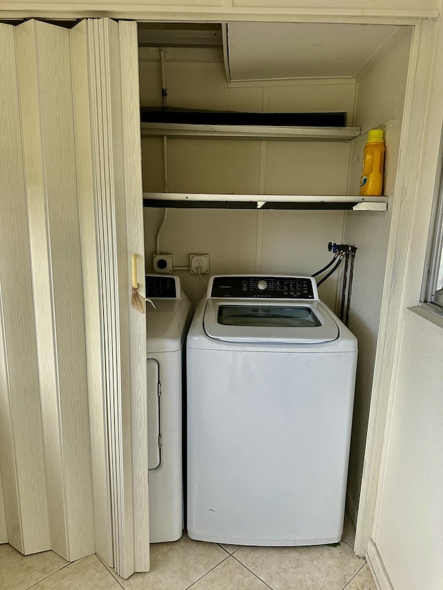 washroom with light tile patterned floors and laundry area
