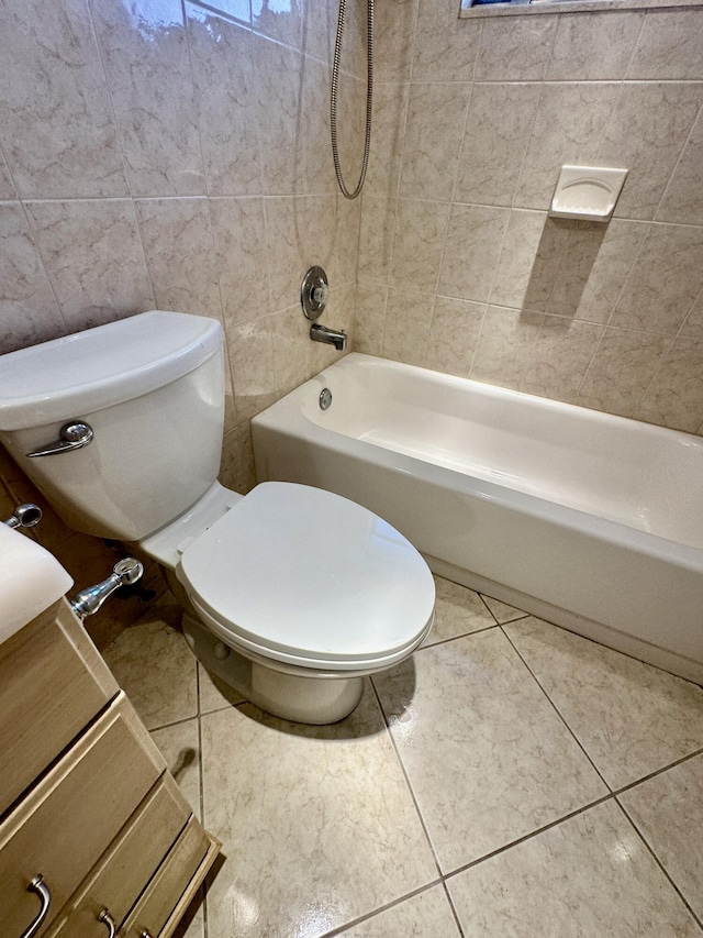 bathroom featuring tile patterned flooring, toilet, tile walls, and washtub / shower combination
