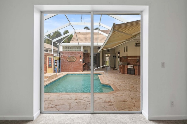 outdoor pool featuring glass enclosure and a patio area