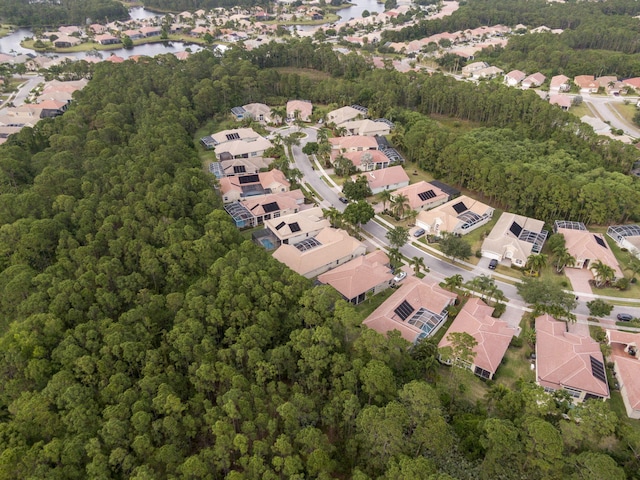 aerial view featuring a water view, a forest view, and a residential view