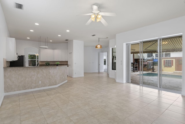 unfurnished living room featuring light tile patterned floors, ceiling fan, visible vents, baseboards, and recessed lighting