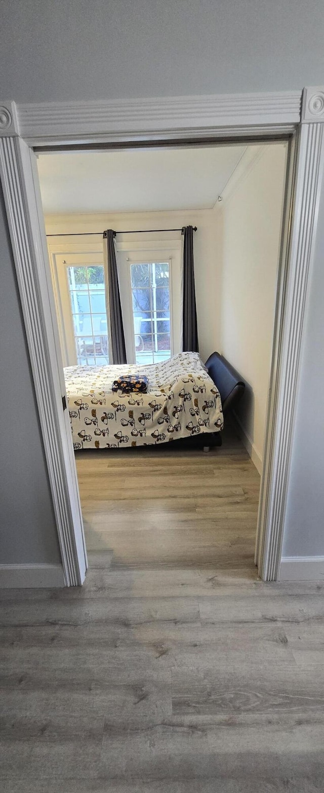 2285 Saratoga Ln, West Palm Beach, FL 33409 - unfurnished bedroom with access to outside, baseboards, and wood finished floors