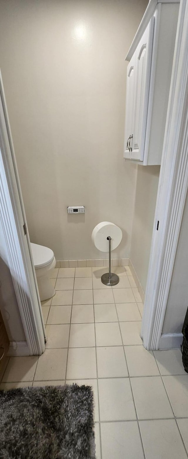 2285 Saratoga Ln, West Palm Beach, FL 33409 - bathroom with toilet, tile patterned floors, and baseboards