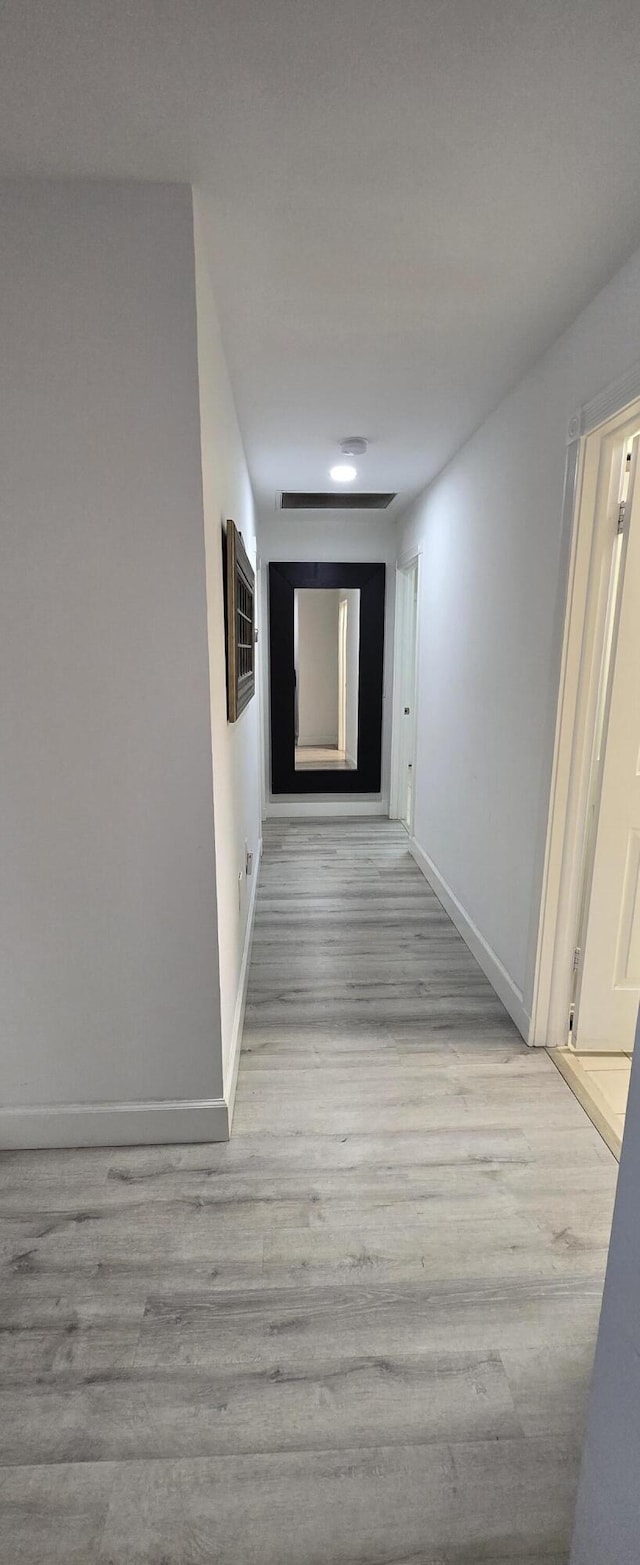2285 Saratoga Ln, West Palm Beach, FL 33409 - hallway with baseboards and wood finished floors