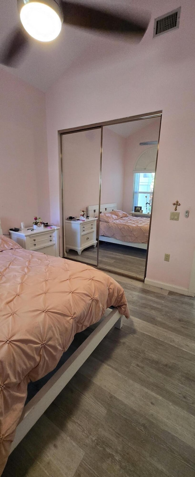2285 Saratoga Ln, West Palm Beach, FL 33409 - bedroom with wood finished floors, baseboards, a ceiling fan, and visible vents